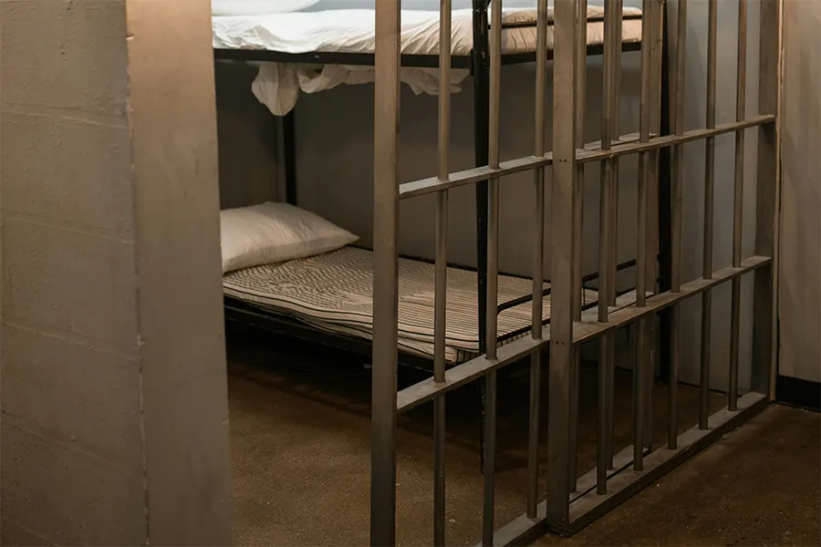 Two beds inside a jail gray wall Impact of Cleanliness