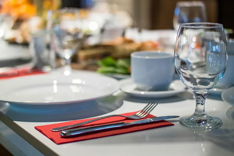 White Plate and cup next red napkins and wine glass over table Kitchen Commercial kitchen cleaning