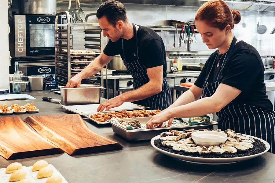 Man and woman serving food on Kitchen Commercial kitchen cleaning